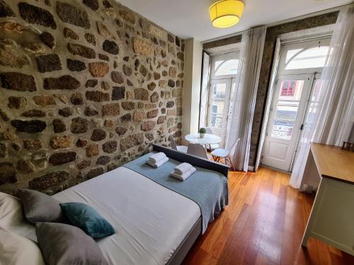 Ένα ή περισσότερα κρεβάτια σε δωμάτιο στο BRAGA BELLS Center Studio
