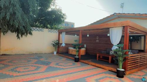 a house with a pavilion on a patio at Royal Dutchess Luxurious Stay Bamburi in Bamburi