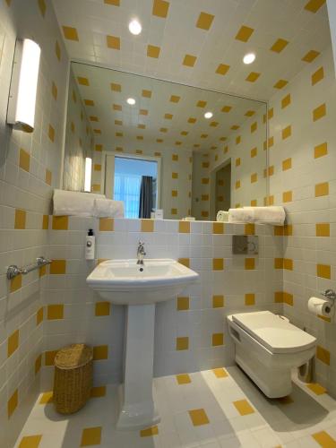 a bathroom with a sink and a toilet at LILOU in Hyères