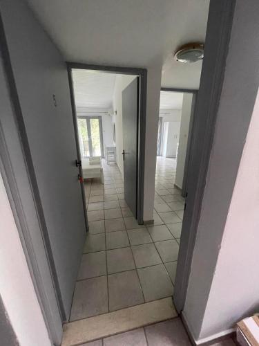 an empty hallway with a door and a tile floor at Maistrato Apartments in Argostoli