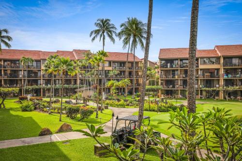an exterior view of the resort with palm trees at Aston at Papakea Resort in Lahaina