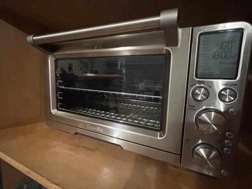 a microwave oven sitting on top of a table at Kin House Guest Suite in Oakhurst