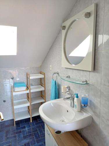 a bathroom with a sink and a mirror at Apartmani Saška 2 in Privlaka