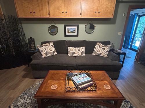 a living room with a couch and a coffee table at Kin House Guest Suite in Oakhurst
