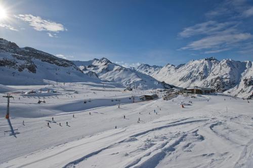 a group of people skiing down a snow covered mountain at Alphotel Garni Salner in Ischgl