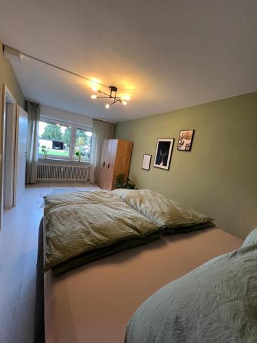 a bedroom with two beds and a window at Moderne, helle Terrassenwohnung im Kurort in Bad Herrenalb