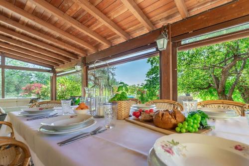 a dining room table with a white table cloth and food at Italian Experience- Villa La Pagliarina in Cartoceto