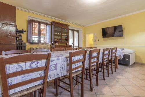 a dining room with a long table and chairs at Italian Experience- Villa La Pagliarina in Cartoceto