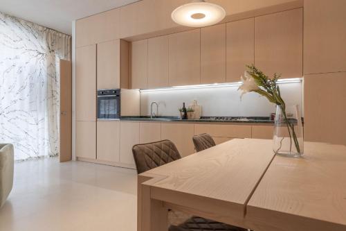 a kitchen with a table with a vase of flowers on it at Italian Experience- Suite Marè in Porto Recanati