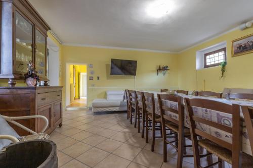 a restaurant with chairs and a bar in a room at Italian Experience- Villa La Pagliarina in Cartoceto