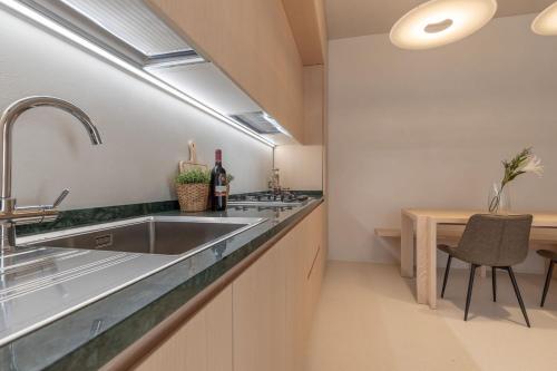 a kitchen with a large sink and a table at Italian Experience- Suite Marè in Porto Recanati
