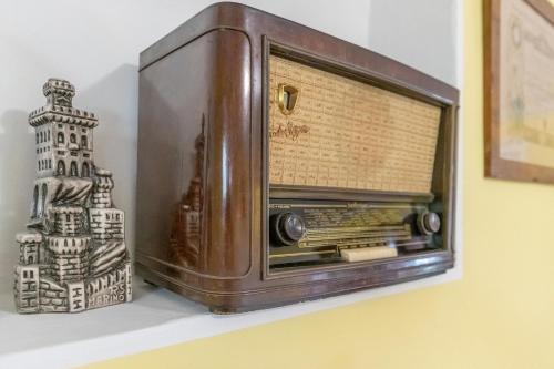 an old radio sitting on a shelf next to a vase at Italian Experience- Villa La Pagliarina in Cartoceto