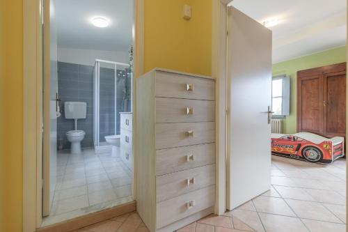 a bathroom with a bedroom with a car on a dresser at Italian Experience- Villa La Pagliarina in Cartoceto