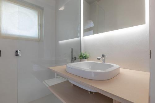 a white bathroom with a sink and a mirror at Italian Experience- Suite Marè in Porto Recanati
