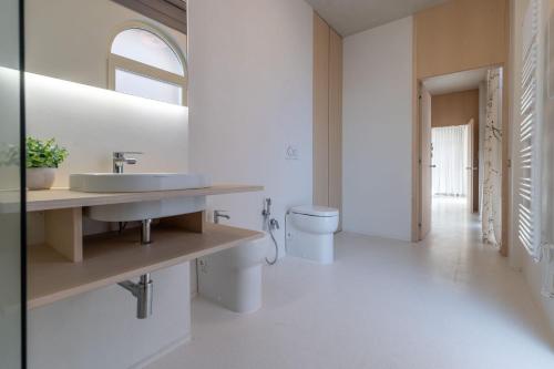 a bathroom with two toilets and a sink at Italian Experience- Suite Marè in Porto Recanati
