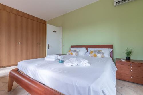 a bedroom with a large white bed with towels on it at Italian Experience- Villa La Pagliarina in Cartoceto