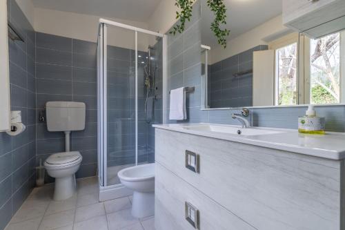 a bathroom with a toilet and a sink and a shower at Italian Experience- Villa La Pagliarina in Cartoceto