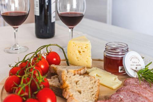 a plate of food with cheese and meat and wine at Italian Experience- Maison Loreto in Loreto