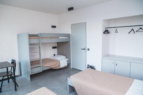 a small bedroom with a bunk bed and a desk at Antwerp Central Youth Hostel in Antwerp