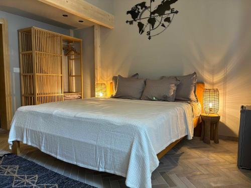 a bedroom with a large white bed with two lamps at Casa Mint in Sozopol