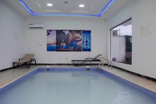 a indoor swimming pool with a large swimming pool at 1Bed - Balcony - Pool - Gym - Spa in Lekki