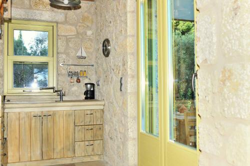 a bathroom with a sink and a window at Mounty Island Villas in Lazaráta