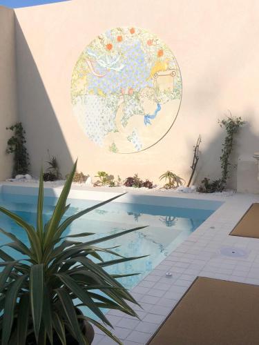 a potted plant next to a swimming pool at LILOU in Hyères
