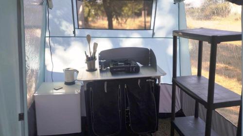 an outside view of a tiny house with a table at Nuraghe Ruiu Villaggio Tende Attrezzate in Norbello
