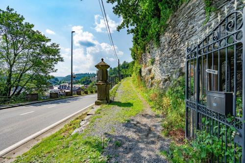 an iron gate on the side of a road at Château Constance, 19 personnes in La Roche-en-Ardenne