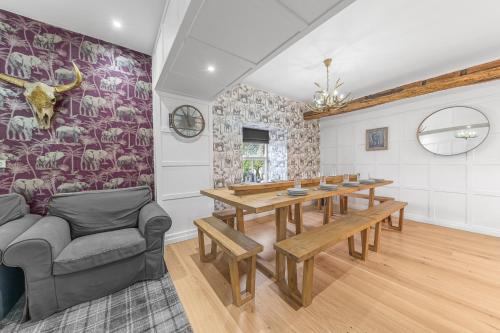 a dining room with a table and a couch at The Redwell Country Inn in Arkholme