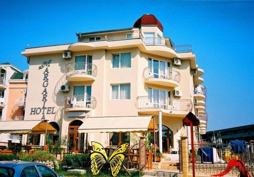a large building with a restaurant in front of it at Hotel Margarita in Kranevo