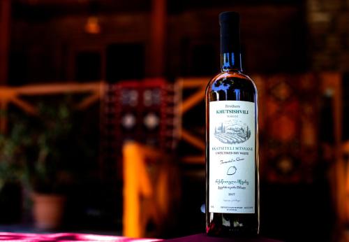 a bottle of wine sitting on a table at Brothers khutsishvili wine cellar in Kisiskhevi