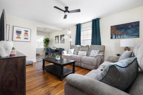 a living room with two couches and a table at 4BR House Minutes From BMS & Bristol Casino in Bristol