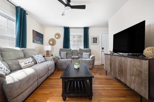 a living room with a couch and a flat screen tv at 4BR House Minutes From BMS & Bristol Casino in Bristol