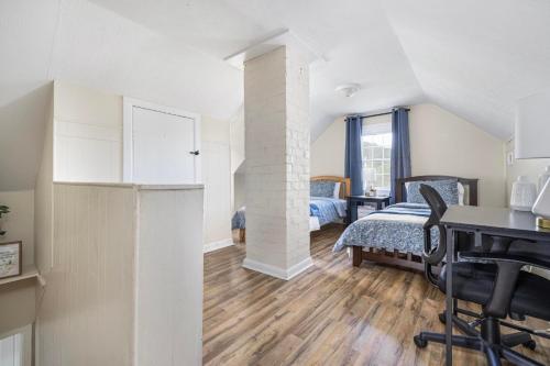 a bedroom with a bed and a desk in a room at 4BR House Minutes From BMS & Bristol Casino in Bristol