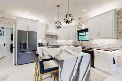 a kitchen with white cabinets and a marble counter top at Town of Lewes --- 132 New Rd. in Lewes