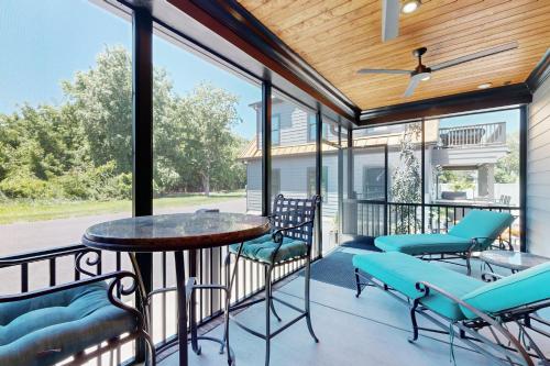 a screened in porch with a table and chairs at Town of Lewes --- 132 New Rd. in Lewes