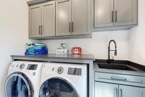 a kitchen with a washing machine and a sink at Town of Lewes --- 132 New Rd. in Lewes