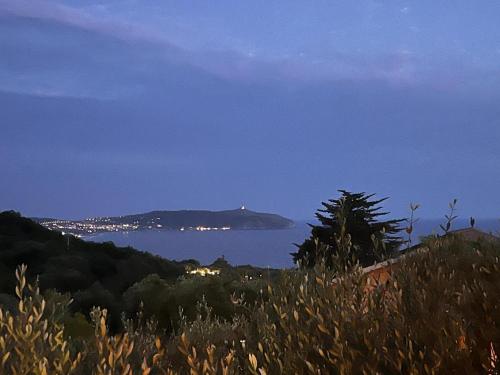 a view of the ocean from a hill at night at Residence Il Casale in Palinuro