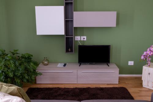 a living room with a flat screen tv on a dresser at FP Apartments Pizzo in Pizzo