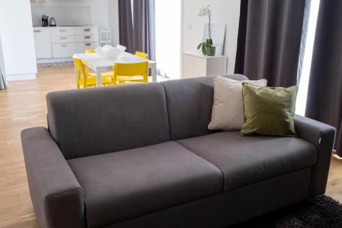 a couch with two pillows on it in a living room at FP Apartments Pizzo in Pizzo