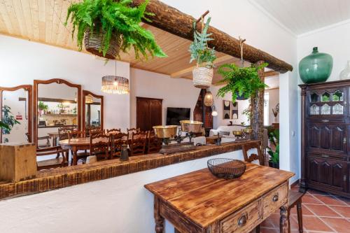 a living room with a table and a mirror at Villa Sado in Alcácer do Sal
