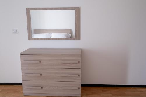 a dresser in a white room with a mirror at FP Apartments Pizzo in Pizzo