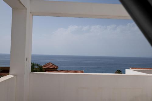 a view of the ocean from a white building at FP Apartments Pizzo in Pizzo