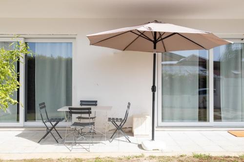 a table and chairs and an umbrella on a patio at FP Apartments Pizzo in Pizzo
