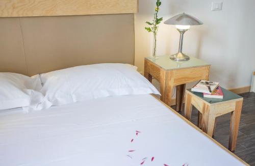 a bedroom with a bed and a table with a lamp at AQUAROOMS Suites in Palermo