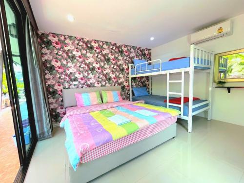 a bedroom with a bed and bunk beds in it at Heartbeat Fall in Love in Sattahip