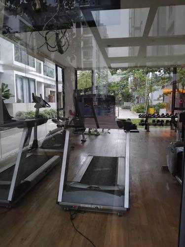 a room with a gym with a large window at Chic n Spacey 3BR apartment at the Rosebay in Surabaya