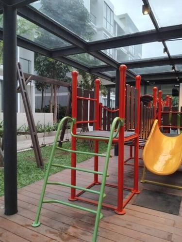 a play area with a playground with a slide at Chic n Spacey 3BR apartment at the Rosebay in Surabaya