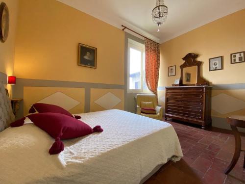 a bedroom with a bed and a dresser and a window at Residenza D'Epoca San Lorenzo Tre in Todi